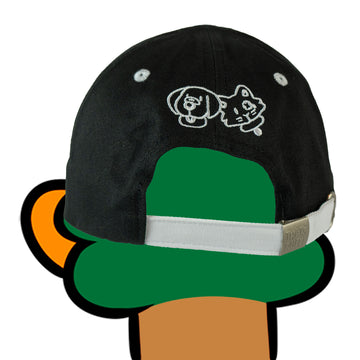 Back view of the Friends Embroidered Cap, worn by a duck character. The cap features white embroidery of two cartoon friends, Ruff the dog and Blotches the cat, on the back. The cap strap has a metal clasp with the 'THAT'S RUFF!' logo embossed.